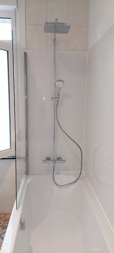 Baignoire avec colonne de douche thermostatique et paroi vitrée installée par YR Sanitaire & Chauffage à Mouscron